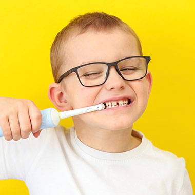 Young child brushing his teeth